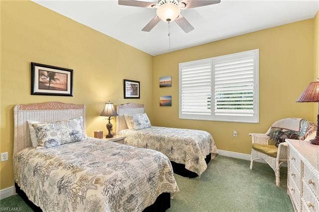11041 Gulf Reflections Dr, #403, Fort Myers, FL 33908 Room featuring a ceiling fan, window with white plantation shutters, and green carpet flooring