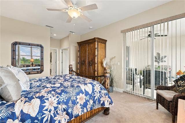 11041 Gulf Reflections Dr, #403, Fort Myers, FL 33908 Neutral-toned wall paint, ceiling fan with integrated lighting, glass sliding door, vertical window blinds, and carpeted flooring