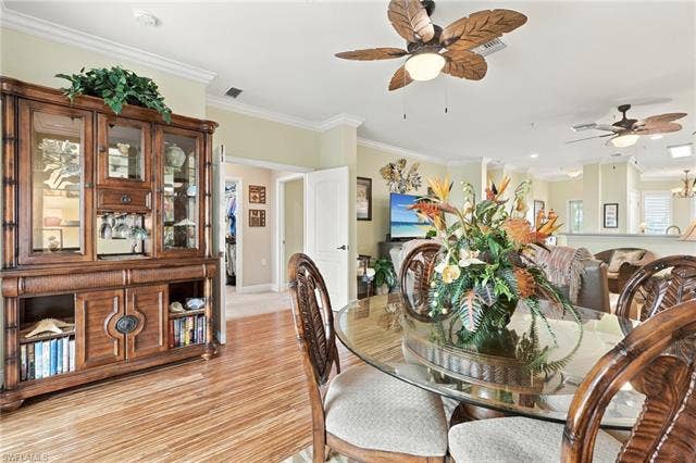 11041 Gulf Reflections Dr, #403, Fort Myers, FL 33908 Wood-finish flooring, crown molding, and ceiling fans with decorative blades