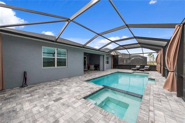 44810 Marina Ln, Punta Gorda, FL 33982 Screened outdoor living area featuring a rectangular pool and integrated spa