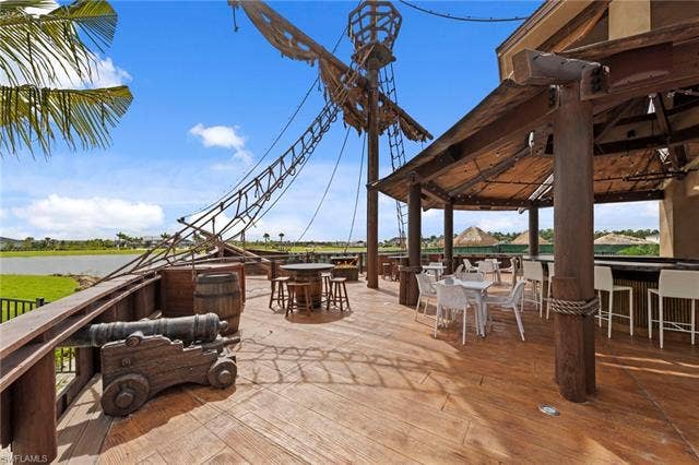 44810 Marina Ln, Punta Gorda, FL 33982 Expansive outdoor deck with a themed pirate ship mast structure, a covered patio area, and a built-in bar