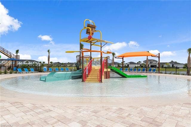 44810 Marina Ln, Punta Gorda, FL 33982 Expansive water play area featuring a multi-level water structure with slides and a tipping bucket, surrounded by a shallow pool