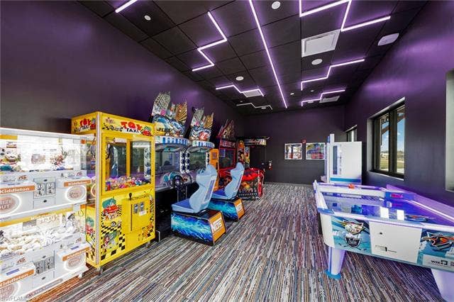 44810 Marina Ln, Punta Gorda, FL 33982 Recreational room with patterned carpet flooring and purple accent walls