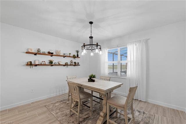 44810 Marina Ln, Punta Gorda, FL 33982 Neutral wall paint, wood-finish tile flooring, recessed ceiling lighting, and a window with blinds