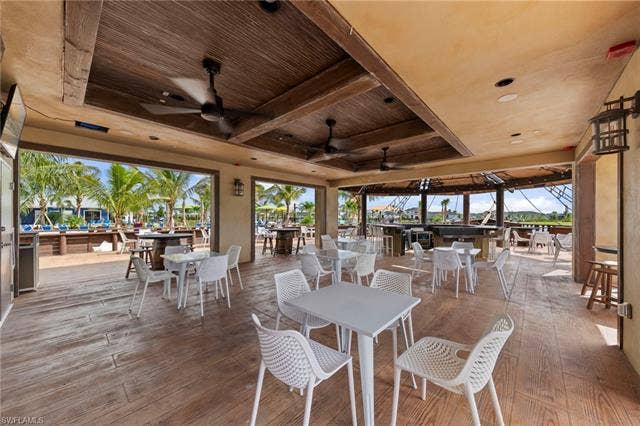 44810 Marina Ln, Punta Gorda, FL 33982 Expansive open-air covered patio featuring wood-finish flooring and a wood-panel ceiling with integrated ceiling fans