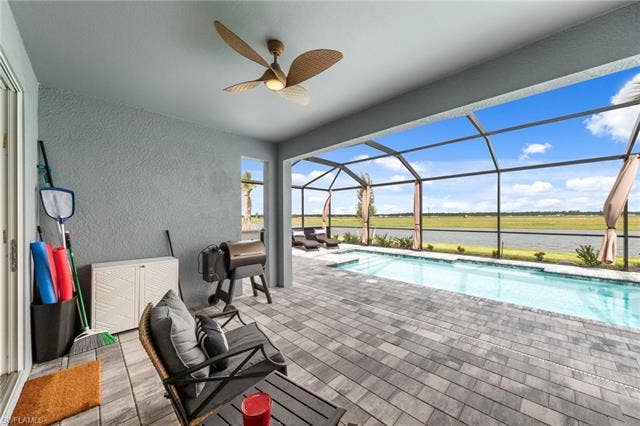 44810 Marina Ln, Punta Gorda, FL 33982 Screened-in patio with a linear pool, ceiling fan, and paver decking