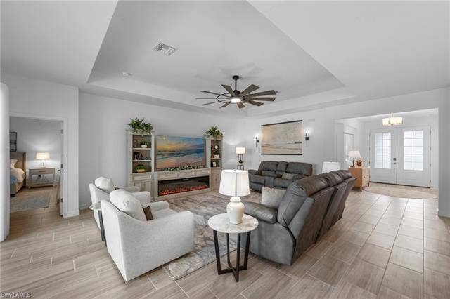 44810 Marina Ln, Punta Gorda, FL 33982 Recessed lighting, wood-finish tile flooring, ceiling fan with integrated lighting, tray ceiling, and built-in entertainment center