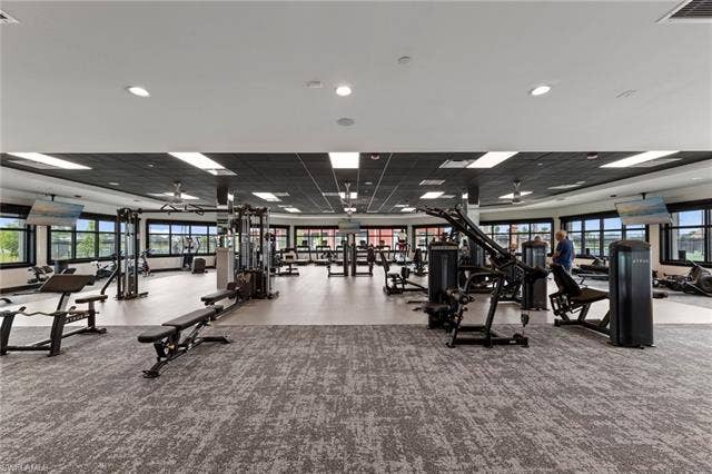 44810 Marina Ln, Punta Gorda, FL 33982 Spacious fitness center featuring varied exercise equipment, expansive window walls, and recessed lighting