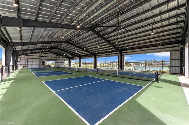 44810 Marina Ln, Punta Gorda, FL 33982 Covered sports courts featuring multiple pickleball surfaces, overhead lighting, large ceiling fans, and a metal roof structure