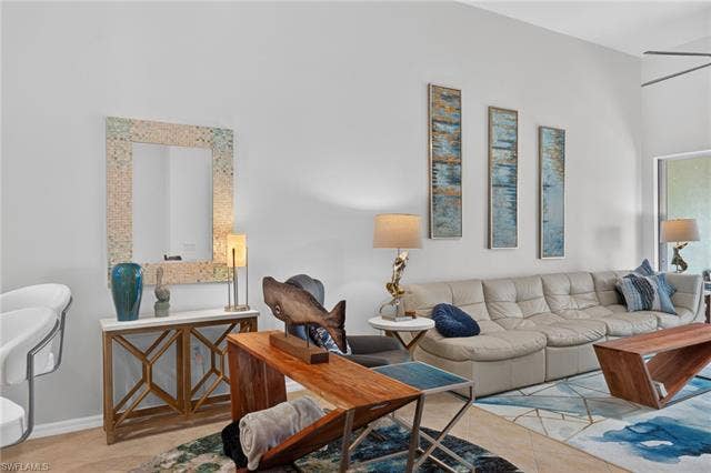 14543 Abaco Lakes Dr, #202, Fort Myers, FL 33908 Bright and airy main living area offering an open-concept layout, soaring ceilings, neutral tones, and ample room for entertaining