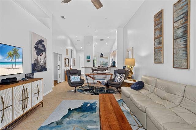 14543 Abaco Lakes Dr, #202, Fort Myers, FL 33908 Alternative open-concept perspective highlighting the great room's generous size, soaring high ceilings, and seamless flow into the kitchen.