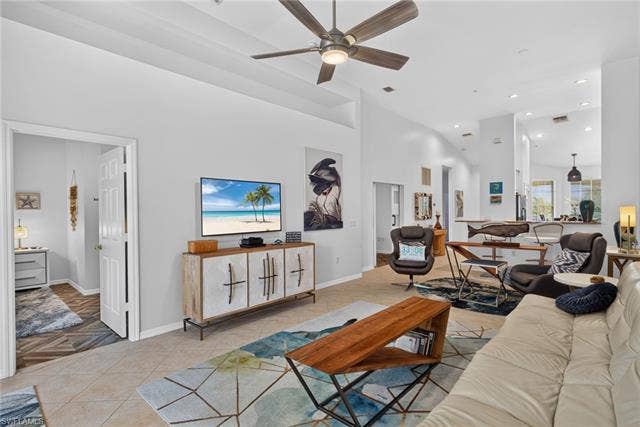 14543 Abaco Lakes Dr, #202, Fort Myers, FL 33908 Sweeping view of the expansive great room, showcasing the primary bedroom entrance, tray ceilings, and an effortless flow into the kitchen.