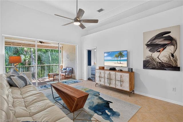 14543 Abaco Lakes Dr, #202, Fort Myers, FL 33908 Generous family room layout highlighted by tray ceilings, contemporary finishes, and wide sliders leading to a private, nature-view balcony