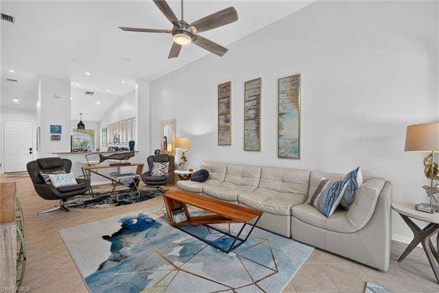 14543 Abaco Lakes Dr, #202, Fort Myers, FL 33908 Expansive open-concept layout showcasing the perfect flow between the vaulted living room, breakfast bar, and kitchen.