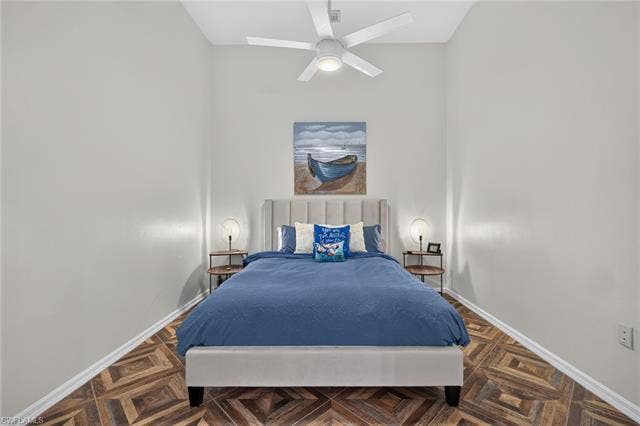 14543 Abaco Lakes Dr, #202, Fort Myers, FL 33908 Bright third bedroom boasting soaring high ceilings, continuous herringbone flooring, a modern ceiling fan, and a comfortable, welcoming layout.