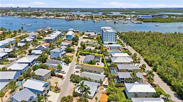 240 Fairweather Ln, Fort Myers Beach, FL 33931 Aerial perspective showcasing the property's proximity to the waterfront - Virtually Edited Image