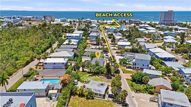 240 Fairweather Ln, Fort Myers Beach, FL 33931 Aerial perspective showcasing the property's proximity to the coastline, with a clear path to beach access - Virtually Edited Image