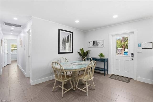 240 Fairweather Ln, Fort Myers Beach, FL 33931 Light gray wood-finish flooring extends throughout this interior space - Virtually Edited Image