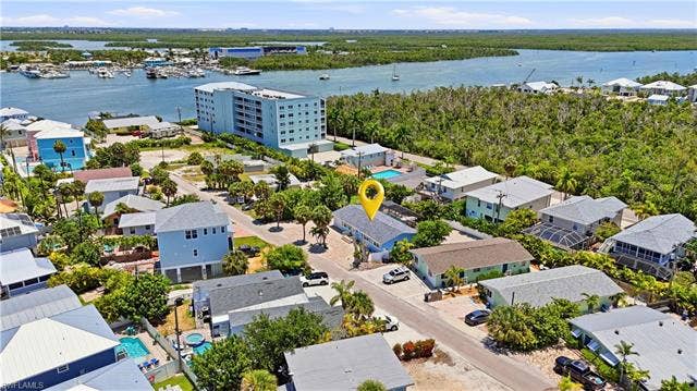240 Fairweather Ln, Fort Myers Beach, FL 33931 Aerial perspective showcasing a residential property with a light-colored roof - Virtually Edited Image