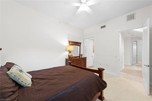 3142 Aviamar Cir, #2104, Naples, FL 34114 White walls, white ceiling fan, and light carpet flooring