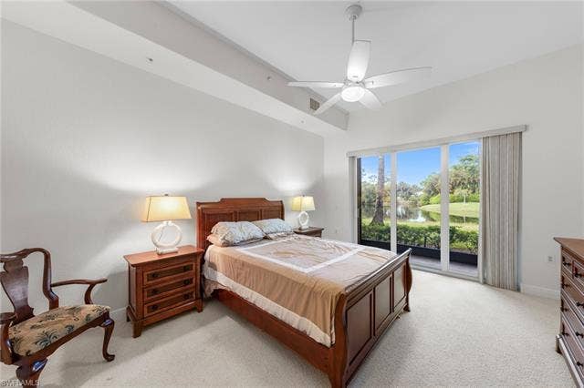 3142 Aviamar Cir, #2104, Naples, FL 34114 Carpeted flooring, white ceiling fan, and large sliding glass doors providing access to the outdoors