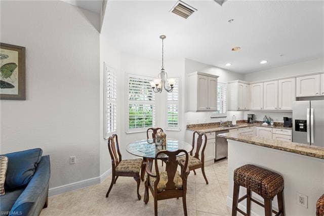 3142 Aviamar Cir, #2104, Naples, FL 34114 Kitchen featuring stainless steel appliances, light-toned cabinetry, and granite countertops