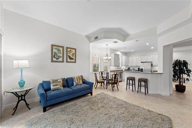 3142 Aviamar Cir, #2104, Naples, FL 34114 Open-concept living area with tile flooring and a tray ceiling