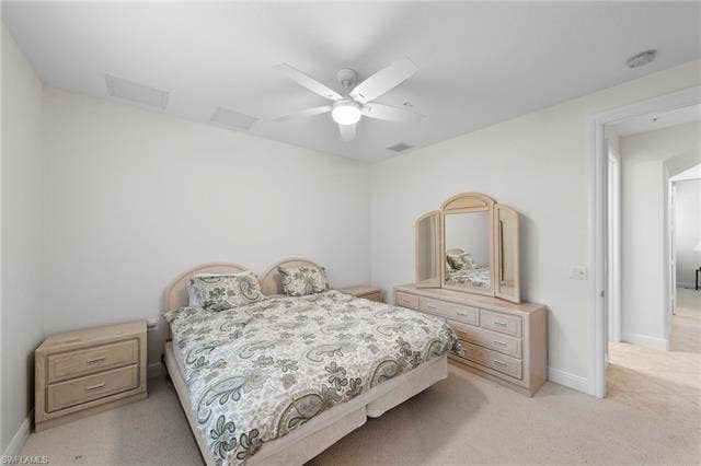 3142 Aviamar Cir, #2104, Naples, FL 34114 Bright secondary bedroom with neutral carpeting, wood-finish furnishings, and ceiling fan