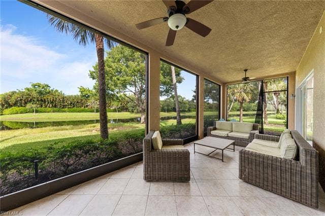 3142 Aviamar Cir, #2104, Naples, FL 34114 Screened lanai featuring tile flooring, multiple ceiling fans, and expansive outdoor exposure
