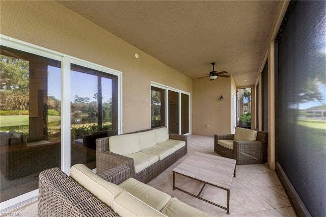 3142 Aviamar Cir, #2104, Naples, FL 34114 Covered patio featuring a ceiling fan, recessed lighting, screen enclosure, and multiple sliding glass doors