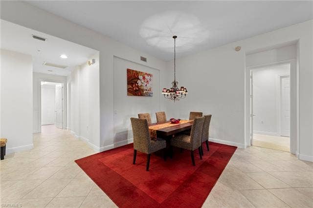3142 Aviamar Cir, #2104, Naples, FL 34114 Spacious open-concept room with neutral tile flooring, recessed lighting, and a decorative chandelier