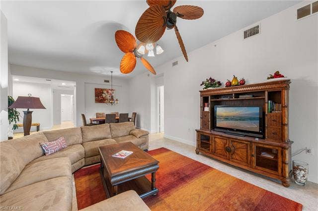 3142 Aviamar Cir, #2104, Naples, FL 34114 Open-concept living area with high ceilings, ceiling fan, tile flooring, and dedicated dining space