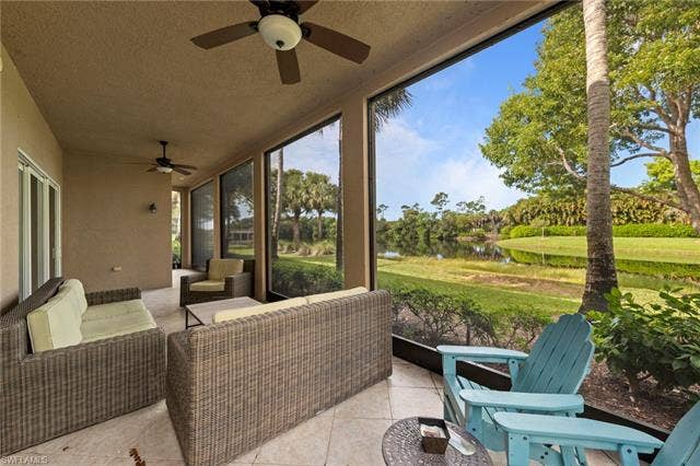 3142 Aviamar Cir, #2104, Naples, FL 34114 Screened lanai with ceiling fans, tile flooring, and sliding glass doors