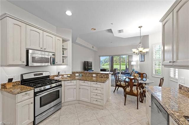 3142 Aviamar Cir, #2104, Naples, FL 34114 Kitchen featuring light-toned cabinetry, stainless steel appliances, and granite countertops