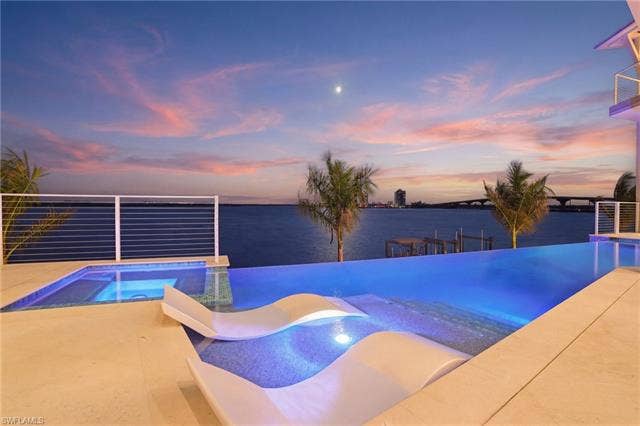 280 Estrellita Dr, Fort Myers Beach, FL 33931 Integrated pool / spa with a patio area and a boat dock - Virtually Edited Image