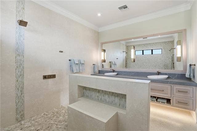 280 Estrellita Dr, Fort Myers Beach, FL 33931 Bathroom featuring a walk in shower, ornamental molding, and vanity - Virtually Edited Image