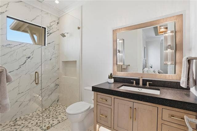 280 Estrellita Dr, Fort Myers Beach, FL 33931 Full bathroom with vanity, a marble finish shower, crown molding, and ensuite bath - Virtually Edited Image