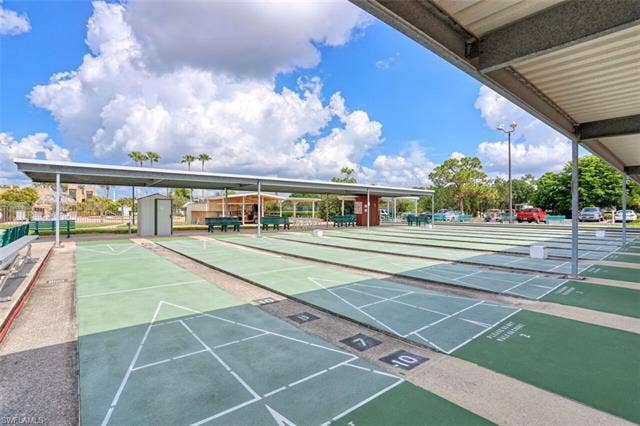 6220 Augusta Dr, #117, Fort Myers, FL 33907 Multiple shuffleboard courts, covered seating areas, and a paved parking lot