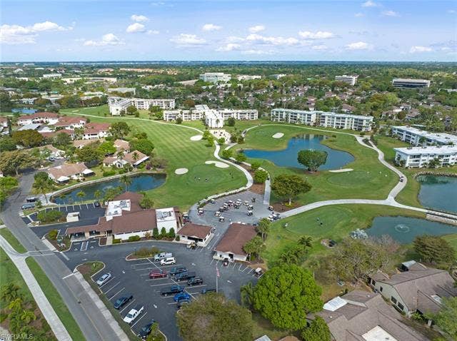 6220 Augusta Dr, #117, Fort Myers, FL 33907 Manicured golf course with multiple water features, surrounded by multi-story residential buildings and lush landscaping