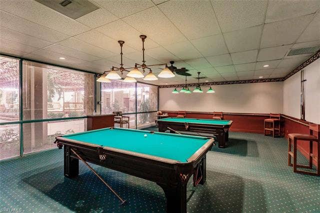 6220 Augusta Dr, #117, Fort Myers, FL 33907 Game room with two billiard tables, overhead task lighting, recessed lighting, and patterned carpeting