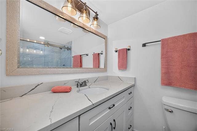 6220 Augusta Dr, #117, Fort Myers, FL 33907 Vanity with white cabinetry, a single basin, and a stone-finish countertop