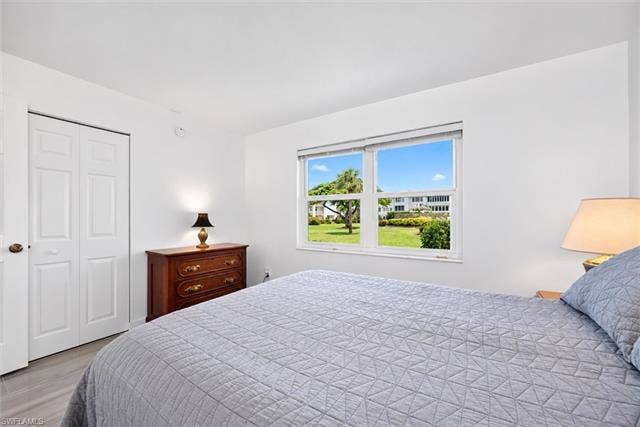 6220 Augusta Dr, #117, Fort Myers, FL 33907 White interior walls, tile flooring, and white bi-fold closet doors