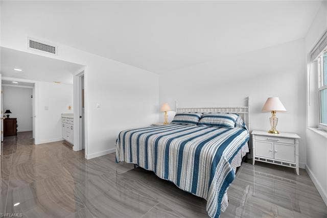 6220 Augusta Dr, #117, Fort Myers, FL 33907 Glossy gray large-format tile flooring, white walls, and a window with a white frame