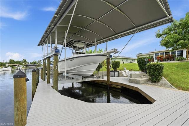 2816 18th Ave, Cape Coral, FL 33904 20k lb covered boat lift. Dock has water, electric, lighting and a submersible fish light.