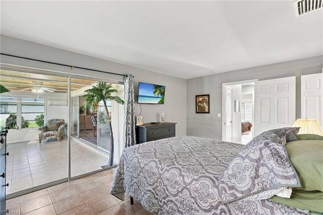 2816 18th Ave, Cape Coral, FL 33904 Sliding glass doors opening to a screened enclosure featuring tile flooring
