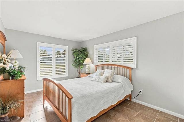 2816 18th Ave, Cape Coral, FL 33904 Dual windows with plantation shutters, tile flooring, and light-toned wall finishes