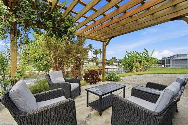 2816 18th Ave, Cape Coral, FL 33904 Outdoor patio featuring a wood pergola and concrete paving