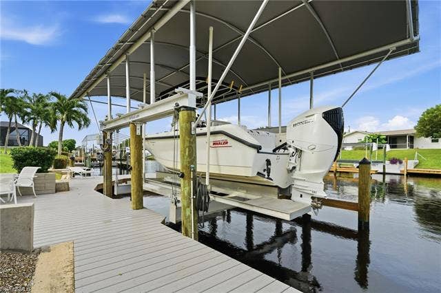 2816 18th Ave, Cape Coral, FL 33904 20k lb covered boat lift. Dock has water, electric, lighting and a submersible fish light.