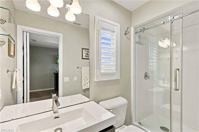 2816 18th Ave, Cape Coral, FL 33904 Integrated vanity with a rectangular sink, modern faucet, and full-width mirror