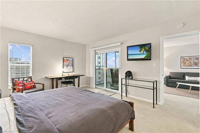 7000 Estero Blvd, #704, Fort Myers Beach, FL 33931 The primary bedroom provides Gulf views, comfortable furnishings and a relaxed coastal atmosphere. - Virtually Edited Image